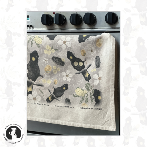 Black Cockatoo tea-towel hanging over oven door | Illustrated by Cal Heath | Full Tea-towel design | by Best in Show | Beige Organic Cotton Tea-towel